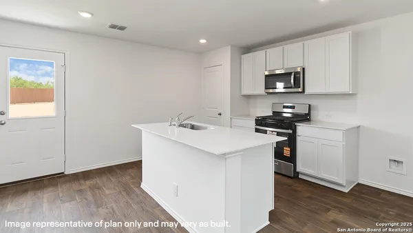 a utility room with cabinets washer and dryer