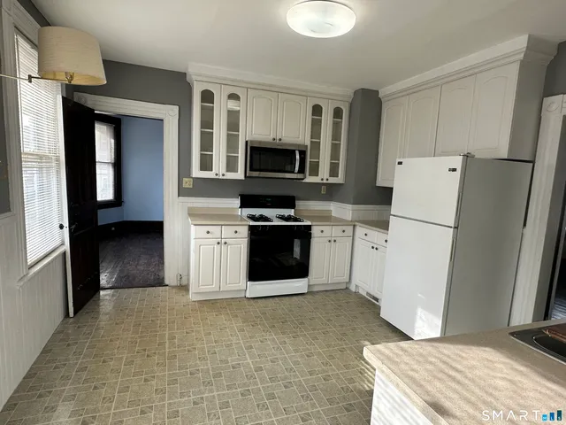 a kitchen with a refrigerator stove and microwave