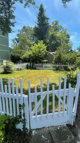 a view of swimming pool with lawn chairs and plants