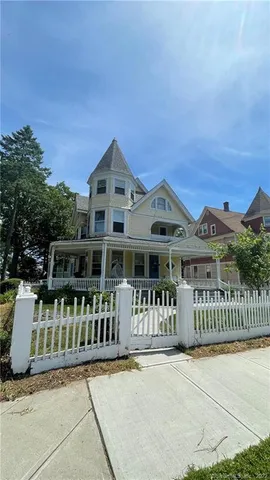 a front view of a house with a garden and deck