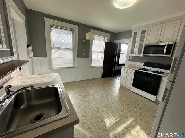 a kitchen with a sink stove and refrigerator