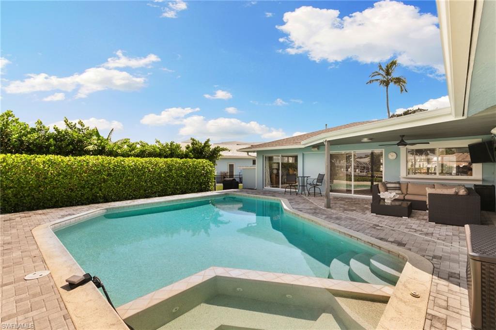 2140 Shad Court Naples, FL 34102 - Photo 21 of 44 a view of a swimming pool with a patio