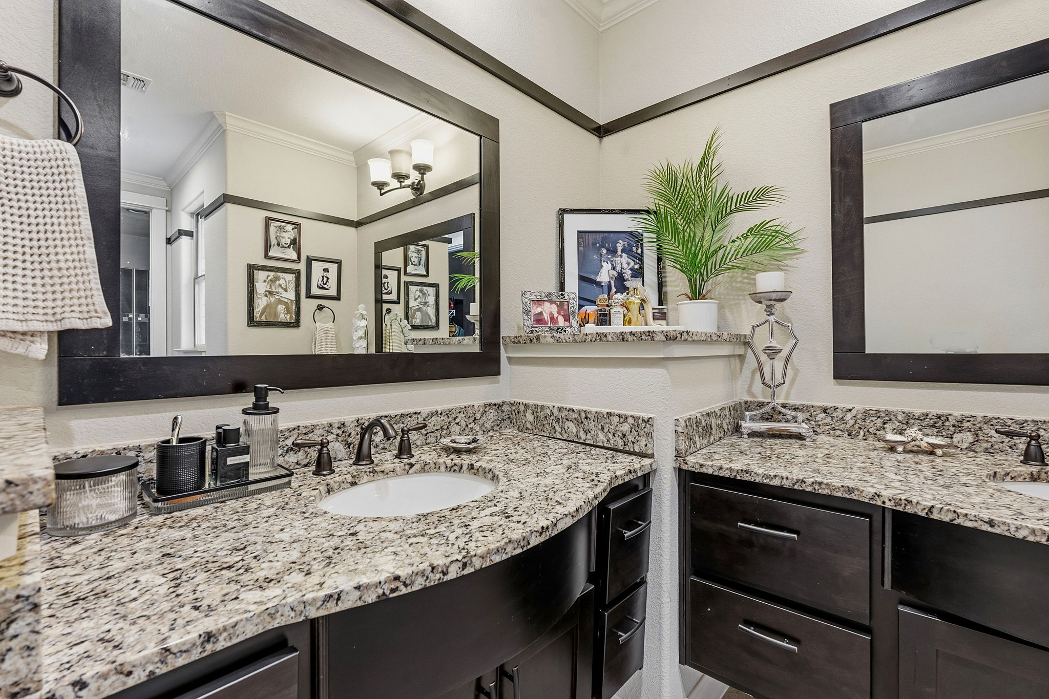 15317 Falconhead Grove Loop Austin, TX 78738 - Photo 16 of 36 Dual vanity with dark wood cabinetry and speckled countertops