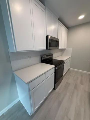 a utility room with cabinets washer and dryer