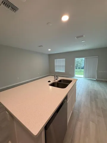 a kitchen with a stove a sink and a refrigerator