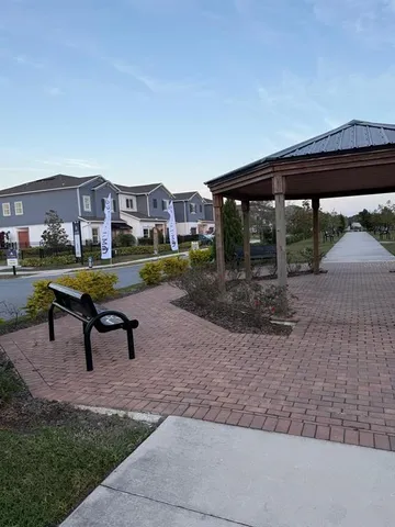 a view of a bench in backyard of house