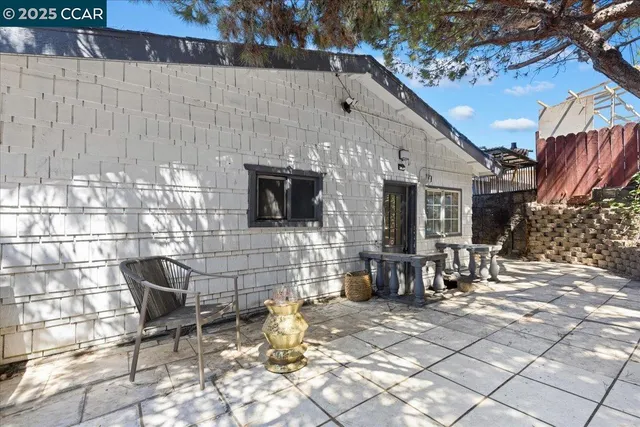 a building outdoor space with patio furniture and potted plants