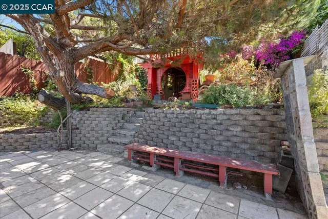 a wooden bench sitting in front of a tree