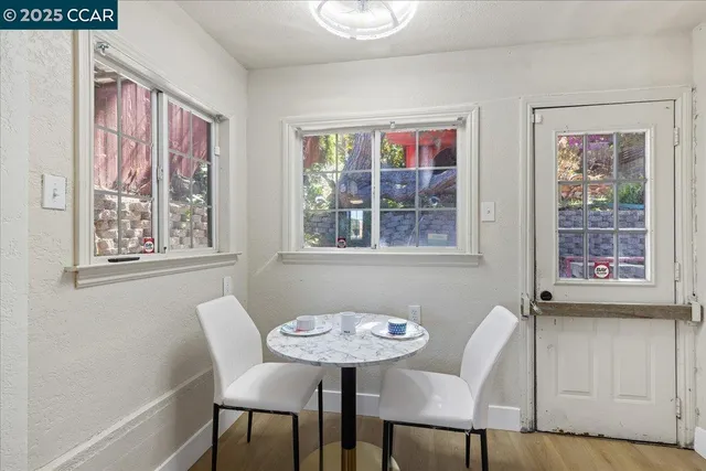 a view of a dining room with furniture and a window