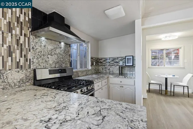a kitchen with stainless steel appliances a stove a sink and a refrigerator