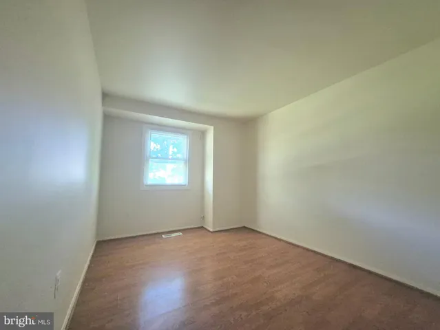 a bathroom with a granite countertop sink a mirror and shower