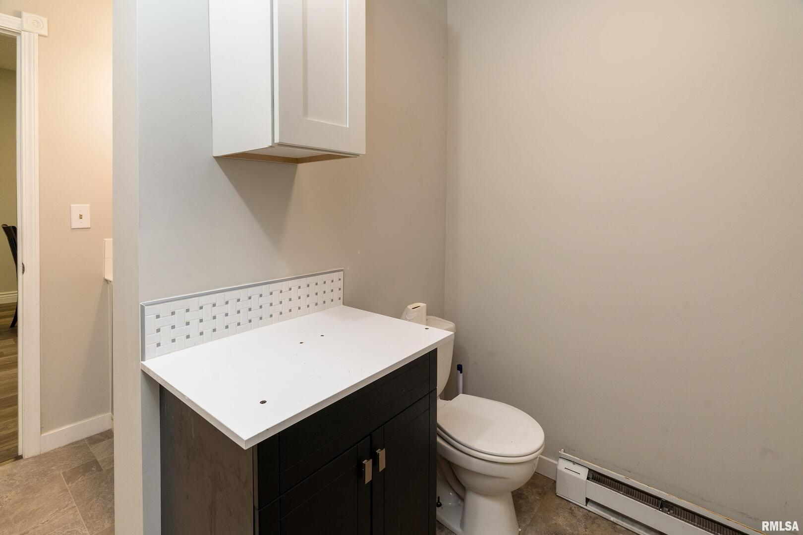 10543 Highway 149 Murphysboro, IL 62966 - Photo 20 of 54 a bathroom with a sink a toilet and vanity