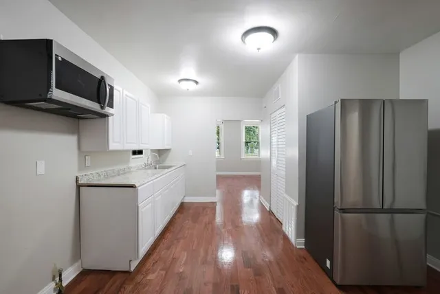 a kitchen with a refrigerator microwave and sink