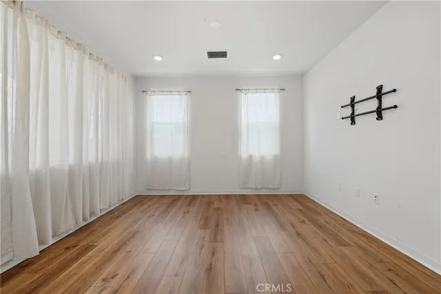 a view of a room with wooden floor and window