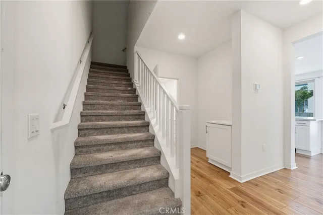 a view of entryway and hall with wooden floor