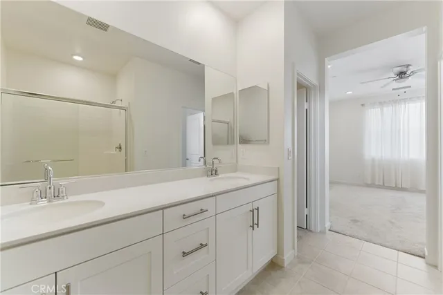 a bathroom with a granite countertop sink a shower and a mirror