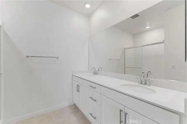 a bathroom with a double vanity sink and a mirror