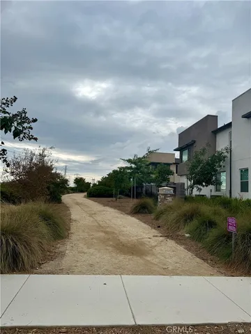 a view of a pathway both side of house with yard