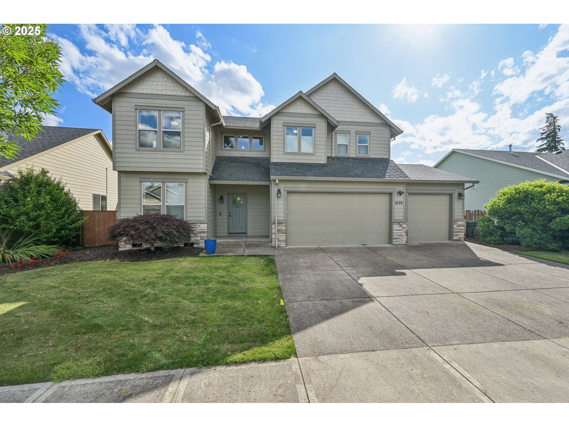 a front view of a house with a garden and plants