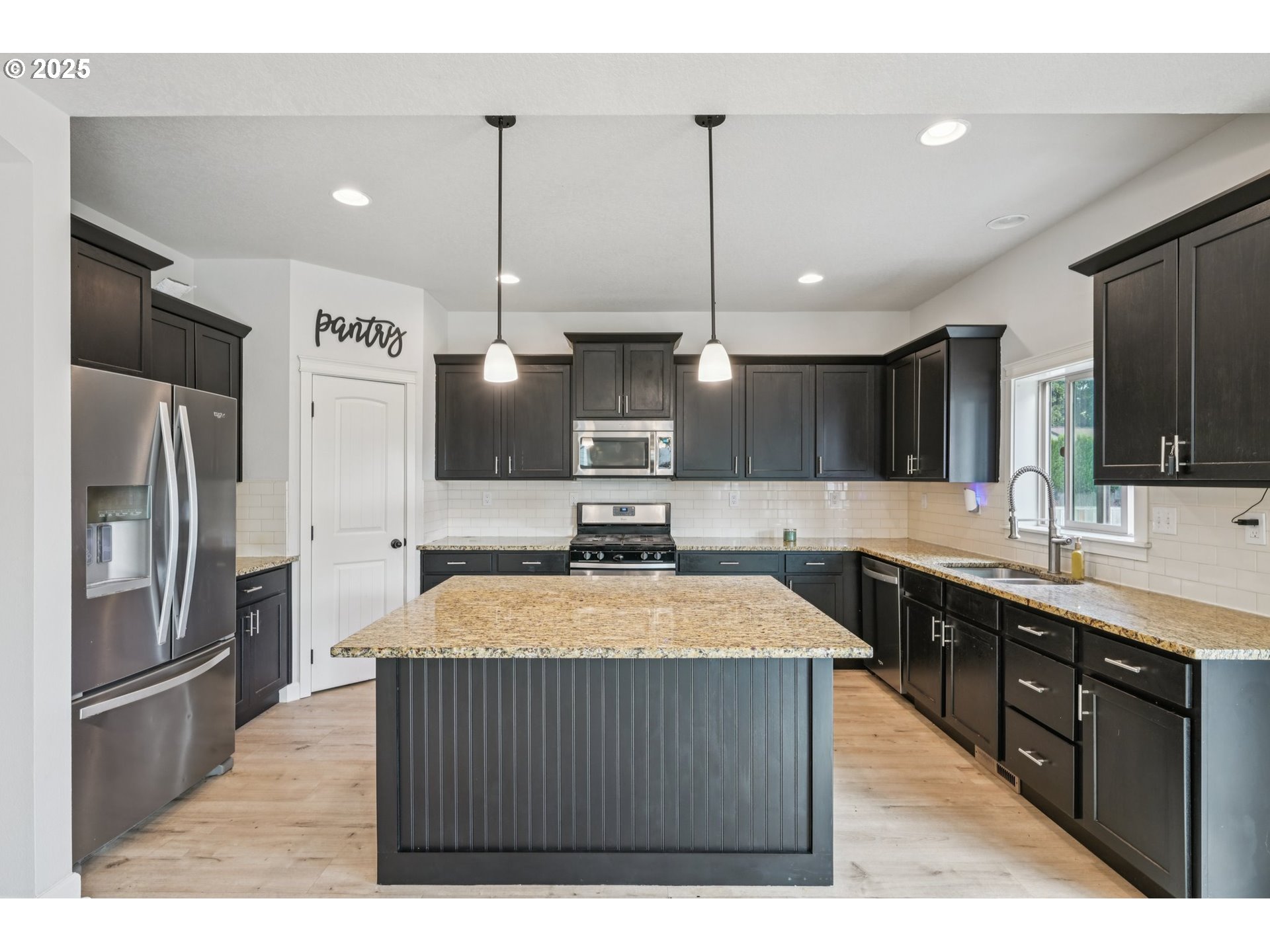 2174 A Street Hubbard, OR 97032 - Photo 5 of 30 a kitchen with stainless steel appliances granite countertop a sink a stove and a refrigerator