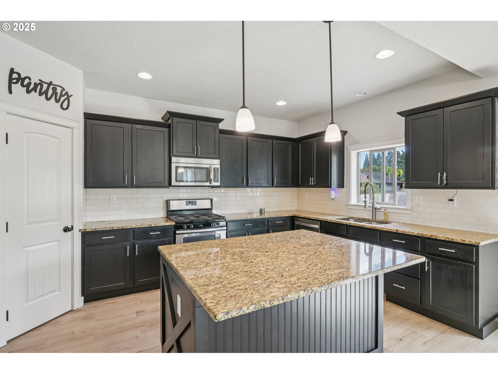 2174 A Street Hubbard, OR 97032 - Photo 6 of 30 a kitchen with kitchen island a sink counter top space appliances and cabinets