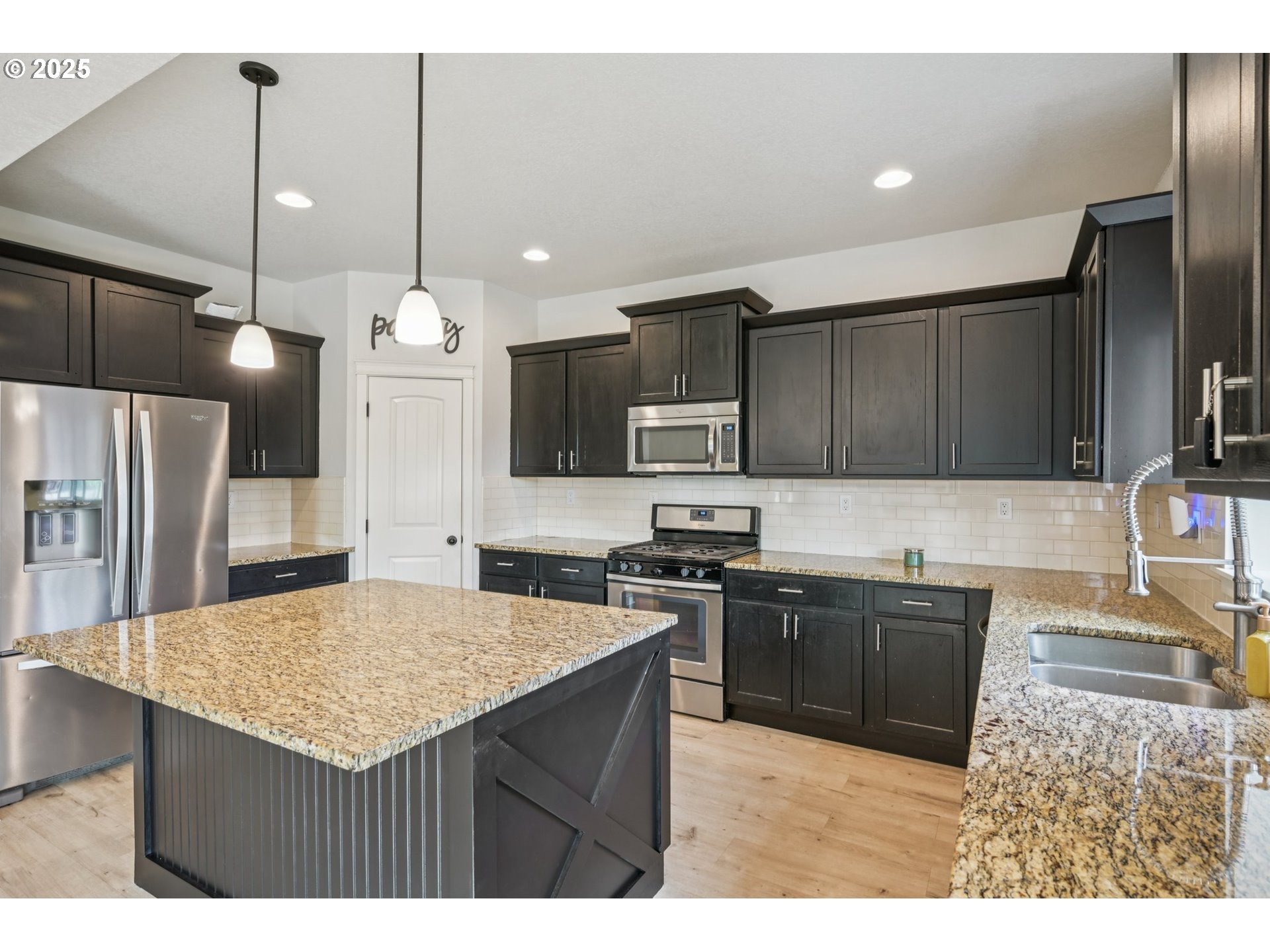 2174 A Street Hubbard, OR 97032 - Photo 7 of 30 a kitchen with stainless steel appliances granite countertop a sink stove and refrigerator