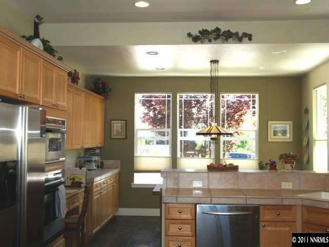 5061 Fall Colors Court Reno, NV 89519 - Photo 4 of 9 a kitchen with stainless steel appliances granite countertop a sink and a refrigerator
