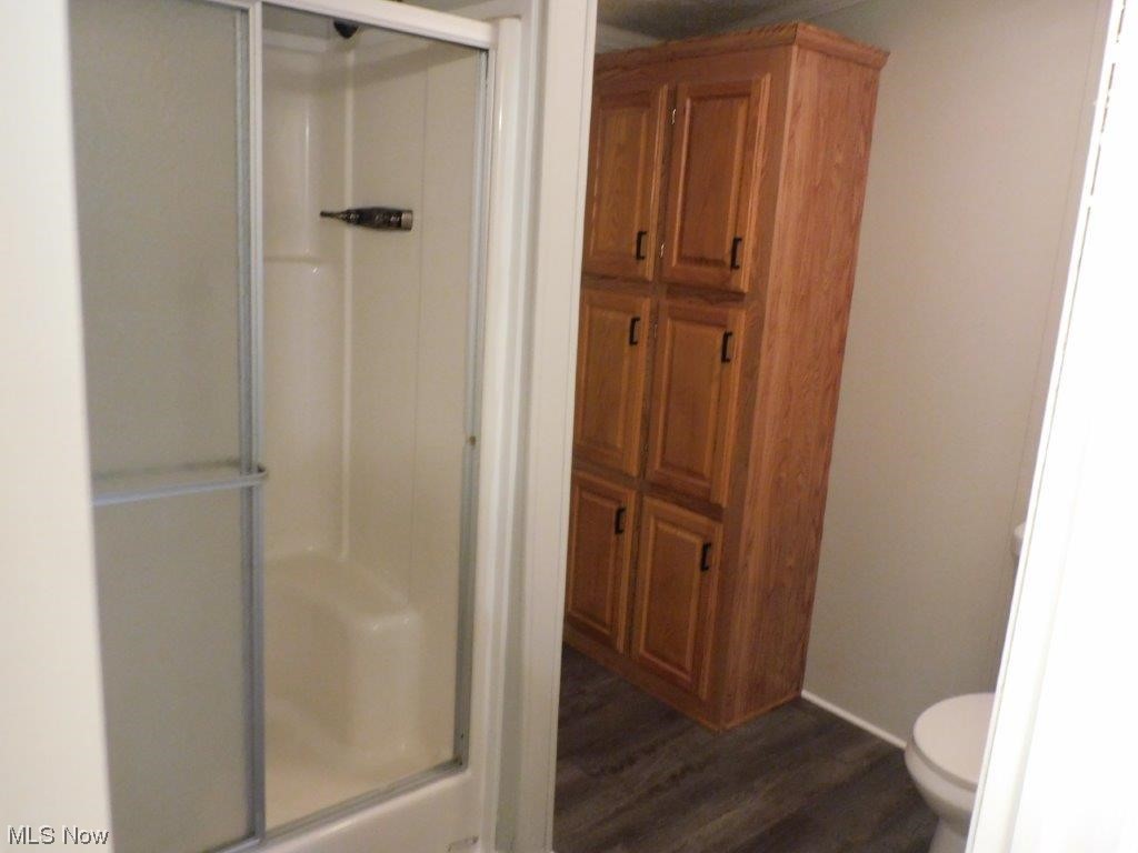 6045 Gore Road Ashtabula, OH 44004 - Photo 17 of 23 Master Bathroom view B with an enclosed shower, hardwood flooring, and toilet