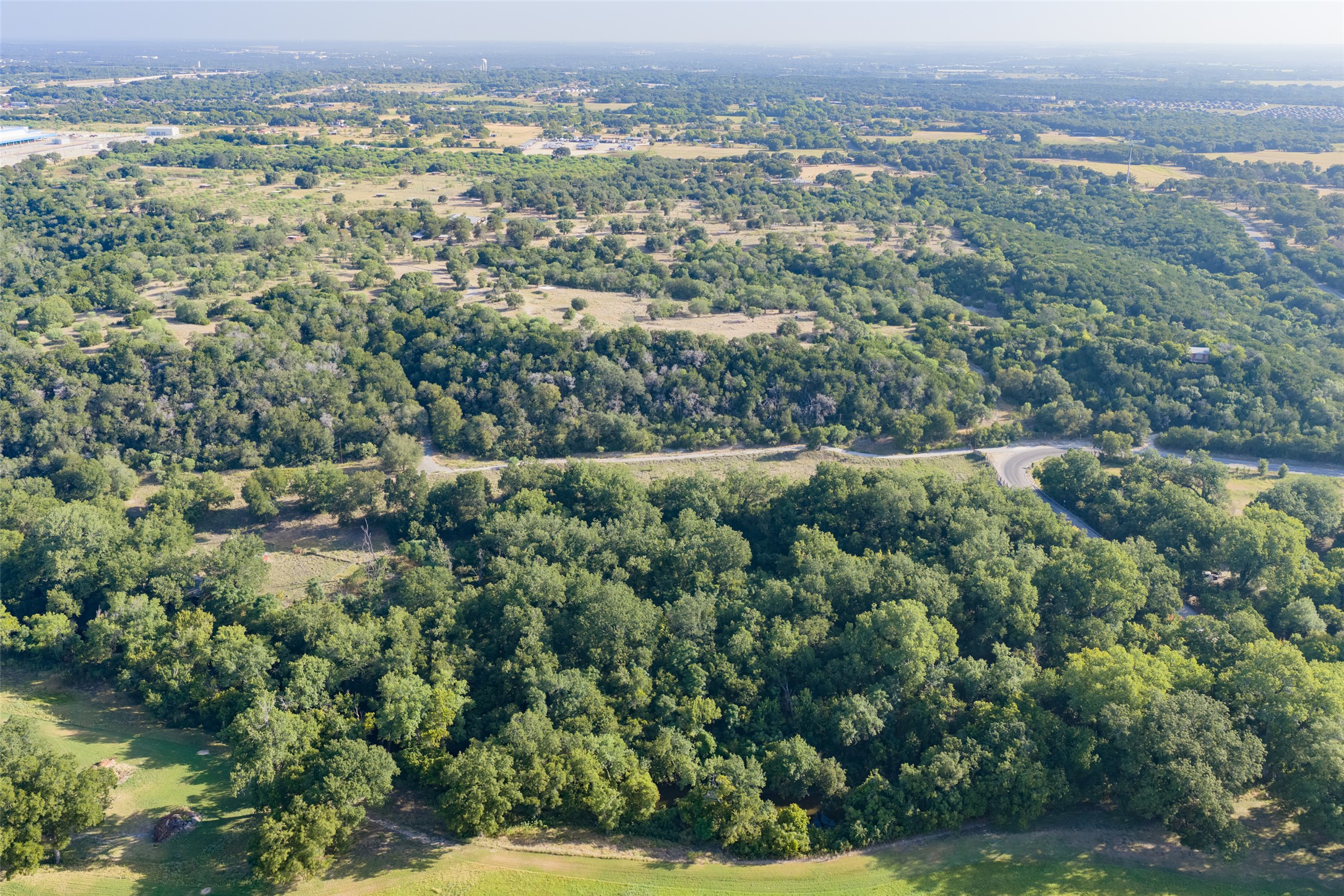 4170 Elm Grove Road Belton, TX 76513 - Photo 8 of 35 Lush green trees and rolling hills stretch across this expansive landscape view.