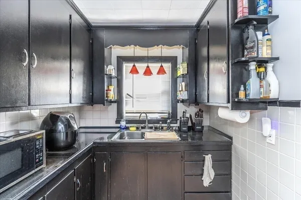 a kitchen with stainless steel appliances a sink and a refrigerator