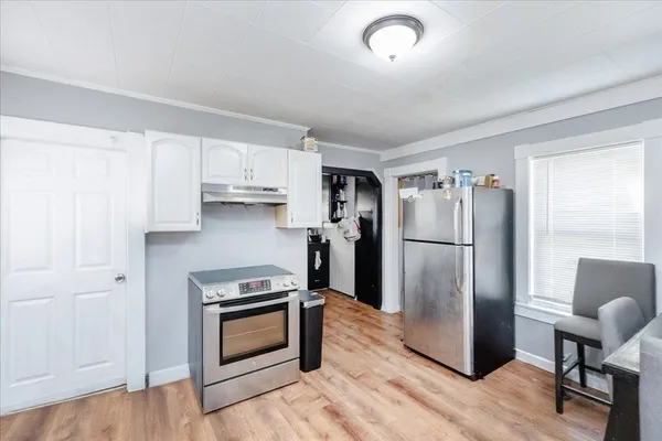 a kitchen with stainless steel appliances a refrigerator and a stove top oven