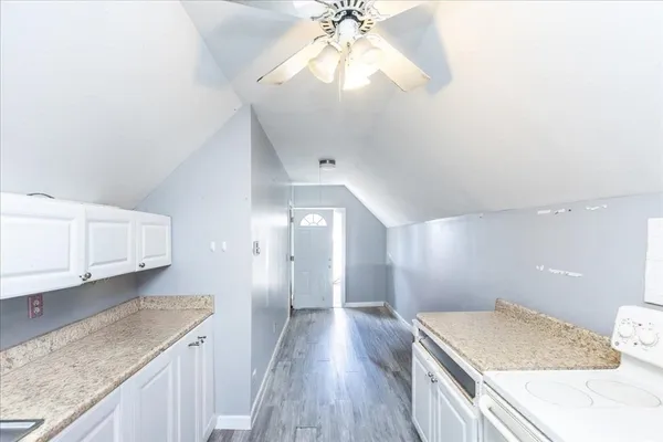a spacious bathroom with a granite countertop sink and a mirror