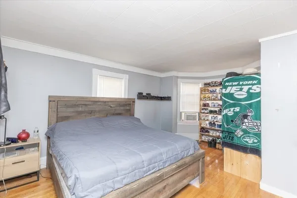 a bedroom with a bed and a chandelier