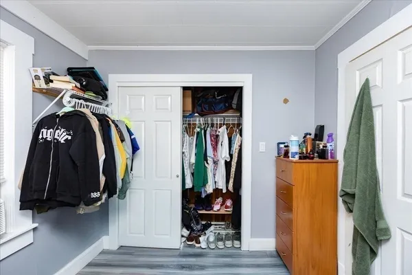 a view of walk in closet with clothes and shoes