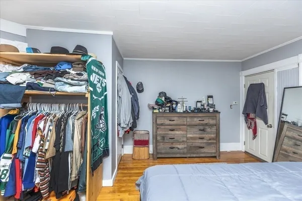 a view of walk in closet with clothes and shoes