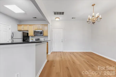 a kitchen with stainless steel appliances granite countertop a sink a stove and a refrigerator