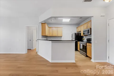 a kitchen with stainless steel appliances granite countertop a refrigerator stove and microwave