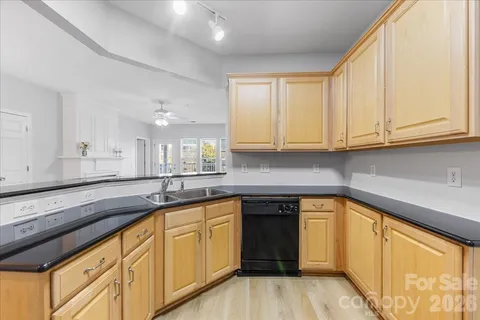a kitchen with stainless steel appliances granite countertop a refrigerator stove a sink and a microwave