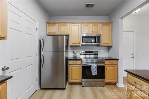 a view of a kitchen with an empty space and a window