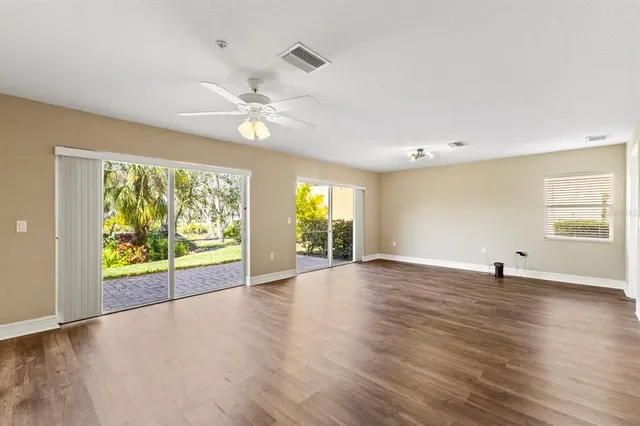 a view of a hallway with wooden floor and closet