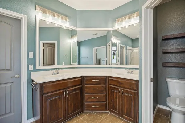 a bathroom with a sink a toilet and a mirror