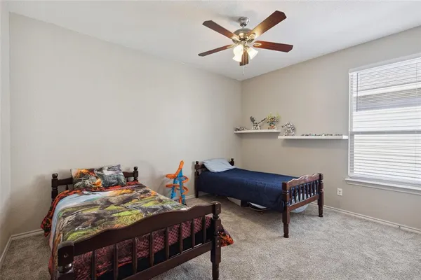 a bedroom with a bed a desk and chair