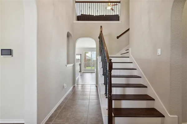 a view of entryway and hall with wooden floor