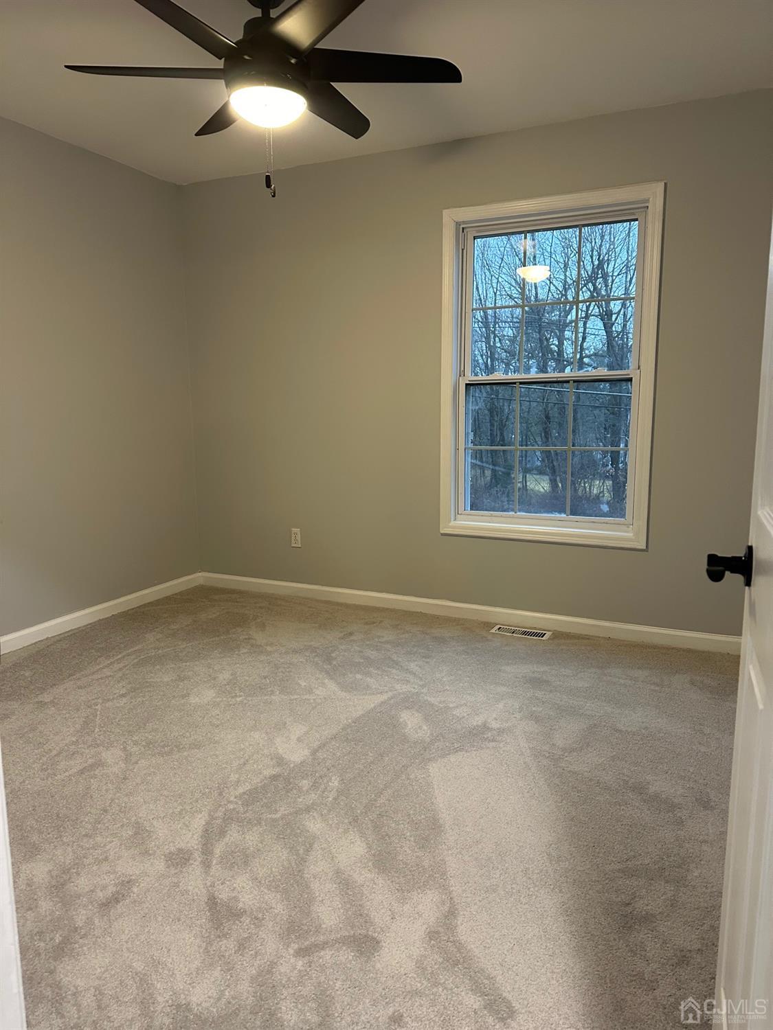 103 Spook Ridge Road Montague, NJ 07827 - Photo 31 of 54 an empty room with a window and ceiling fan