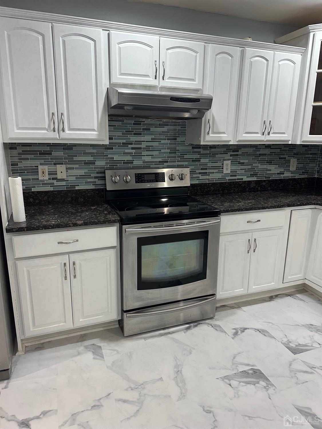 103 Spook Ridge Road Montague, NJ 07827 - Photo 36 of 54 a kitchen with granite countertop white cabinets and appliances