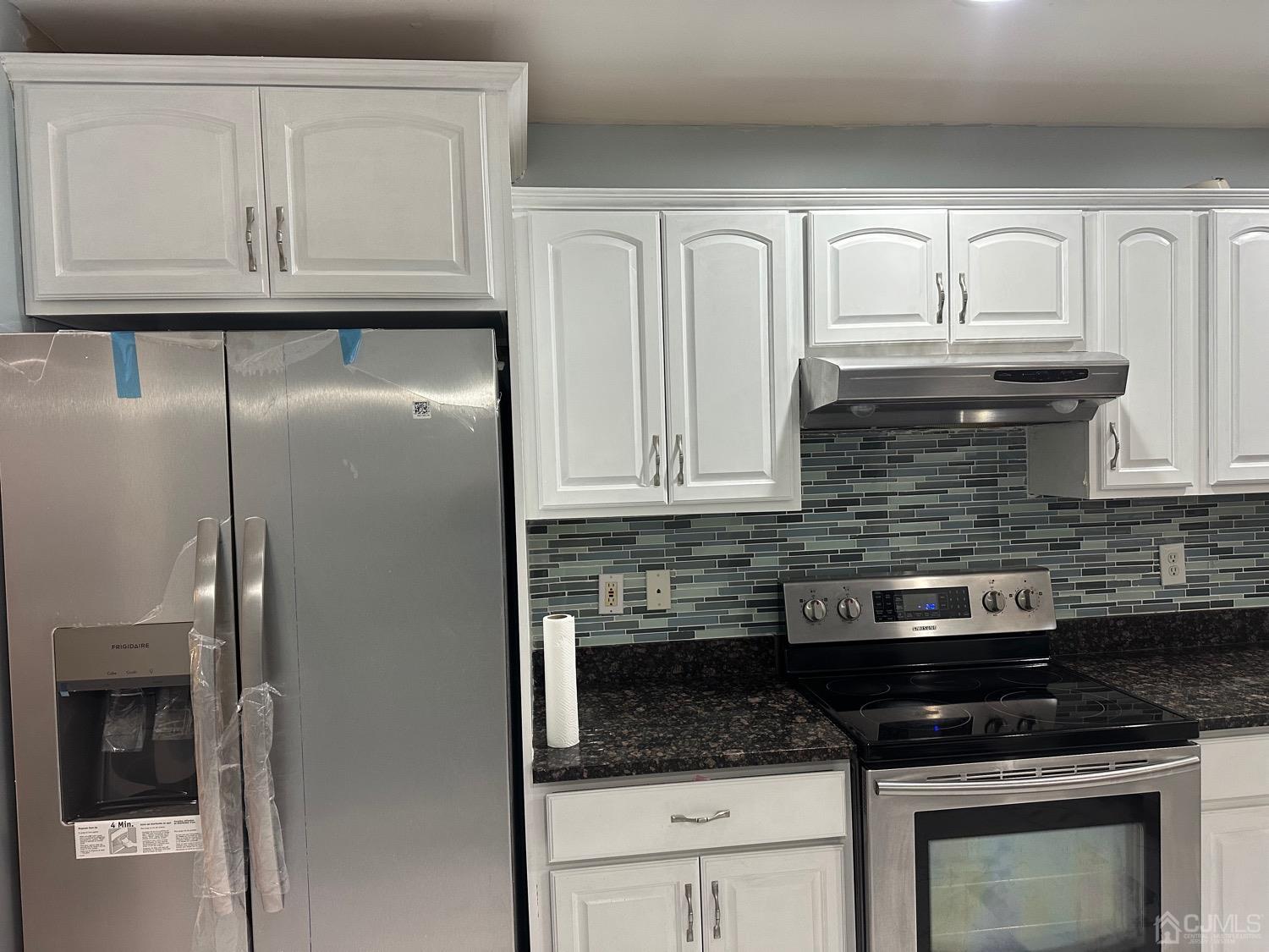 103 Spook Ridge Road Montague, NJ 07827 - Photo 41 of 54 a kitchen with granite countertop white cabinets and a stove