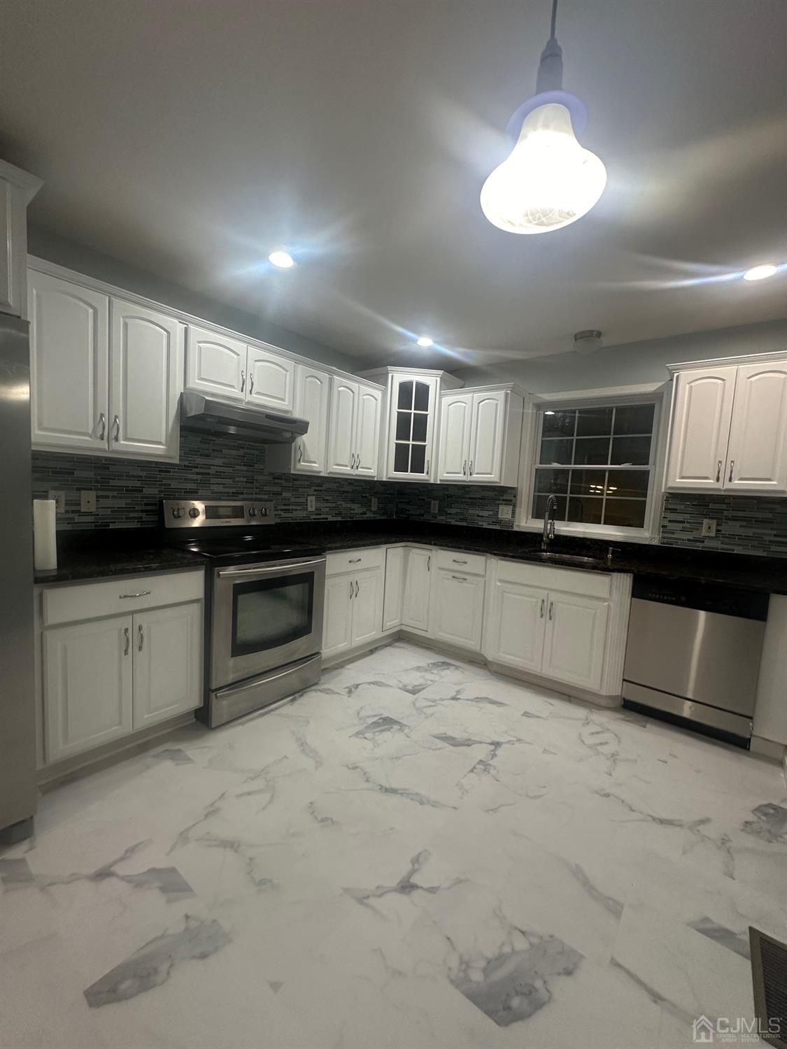 103 Spook Ridge Road Montague, NJ 07827 - Photo 43 of 54 a large kitchen with stainless steel appliances granite countertop a sink and cabinets