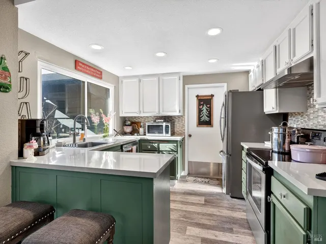 a kitchen with a sink cabinets and stainless steel appliances