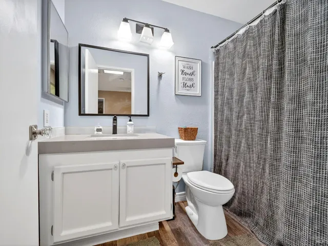 a bathroom with a toilet sink and mirror