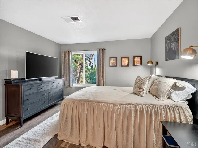 a bedroom with a bed and a flat screen tv